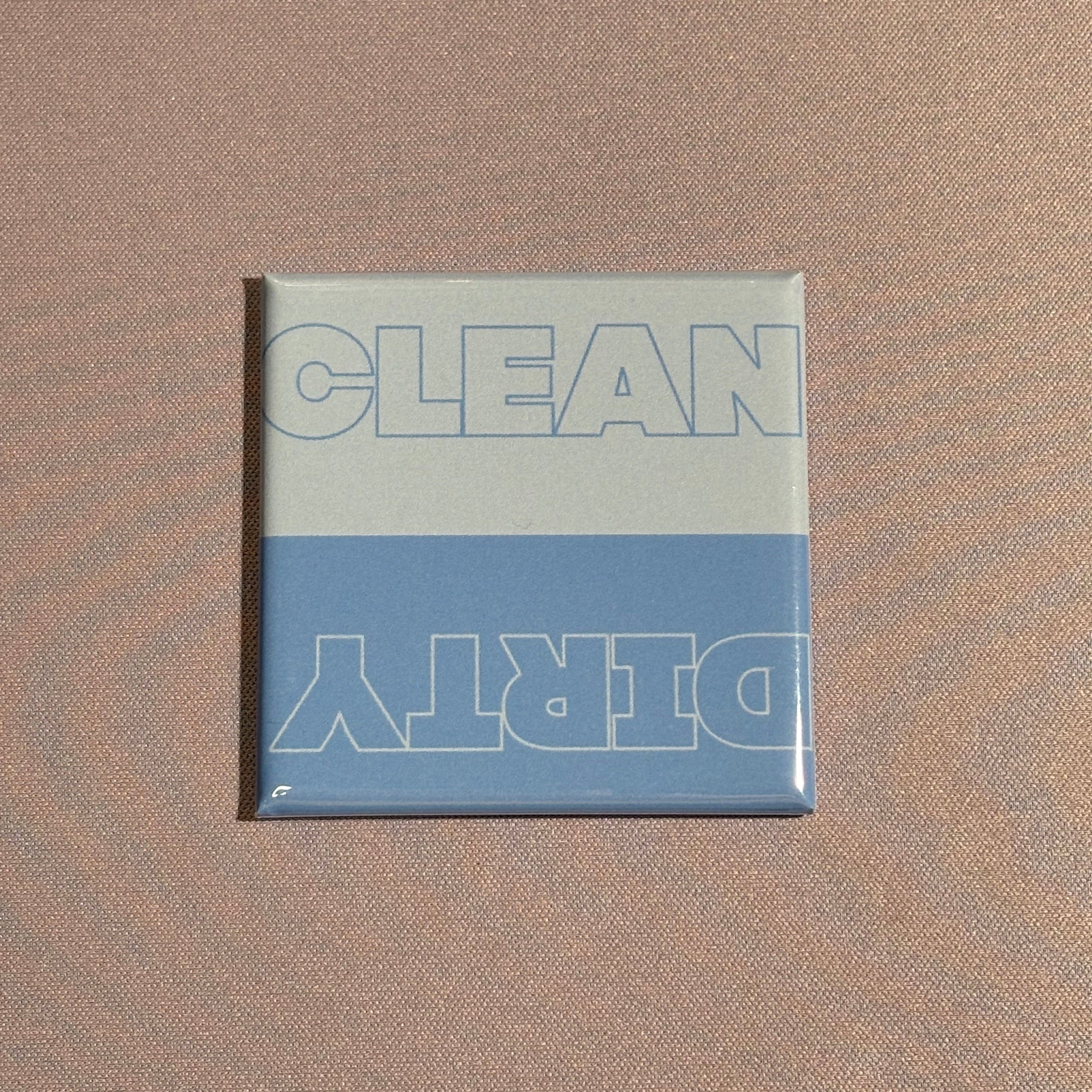 A square magnet with the words clean and dirty on top in a blue color variation. Used for dishwasher.